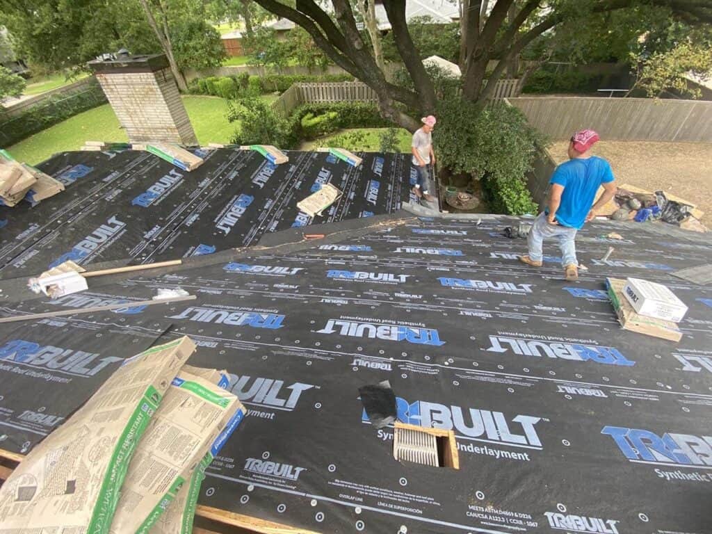 The crew is installing a full synthetic underlayment on the roof.